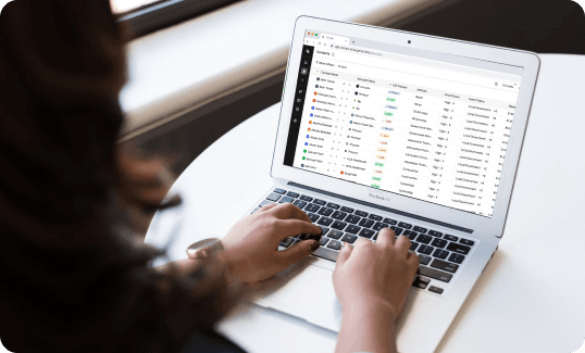 Person working on laptop with spreadsheet