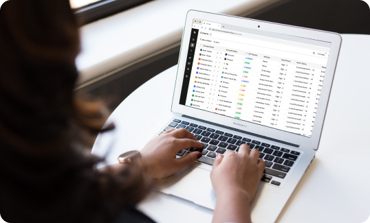 Person working on laptop with spreadsheet